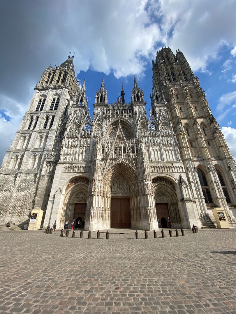 A large cathedral with a clock tower in the background.