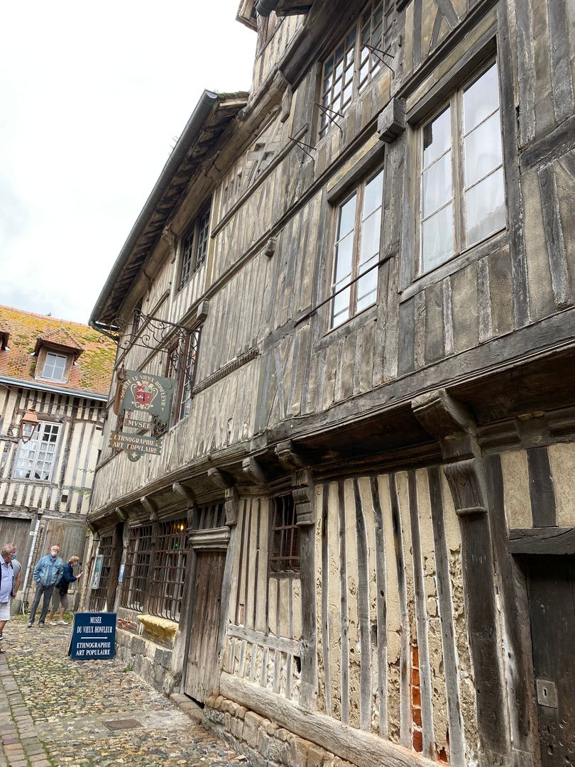 A wooden building with a cobblestone street.
