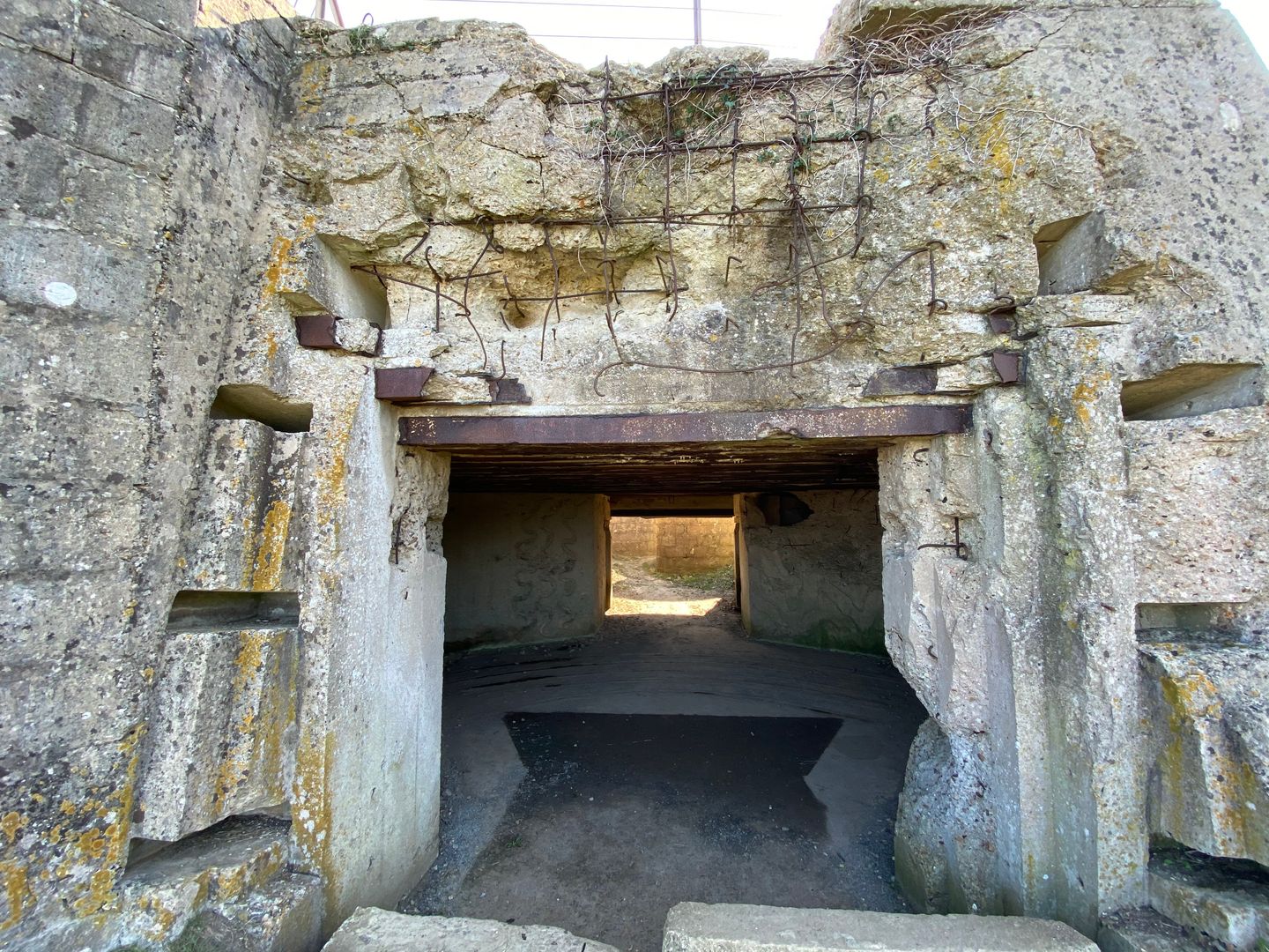 The entrance to a tunnel in a stone wall.