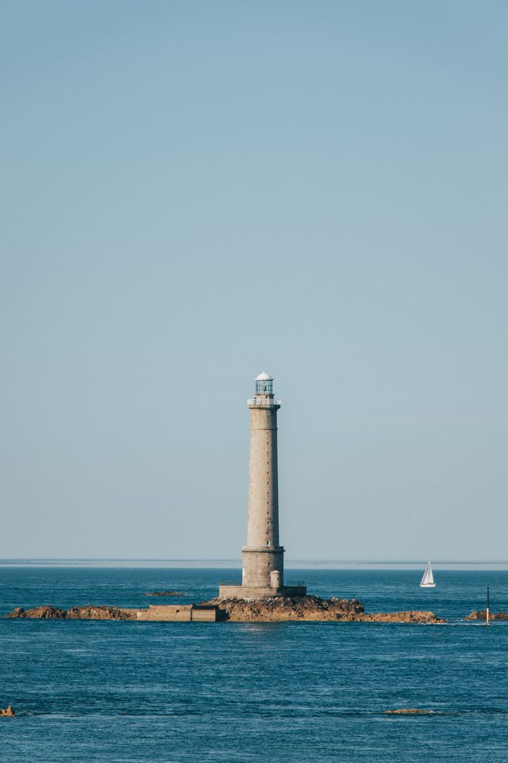 A lighthouse in the middle of the ocean.