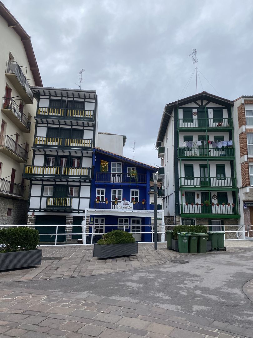 A row of colorful buildings in a plaza.