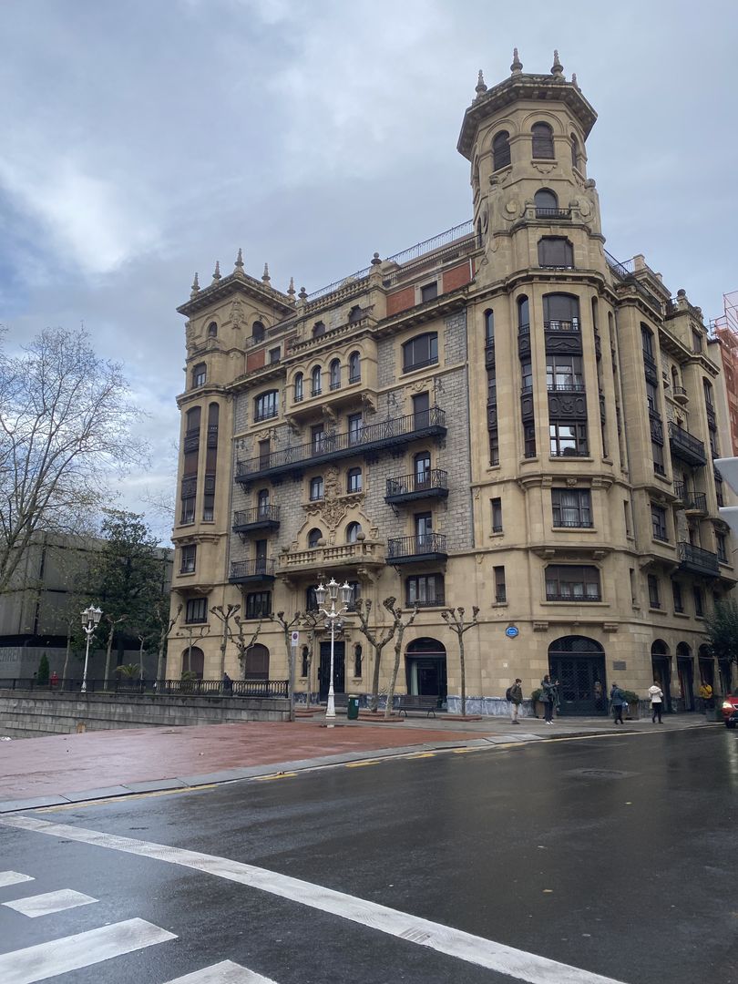 An old building on the corner of a street.