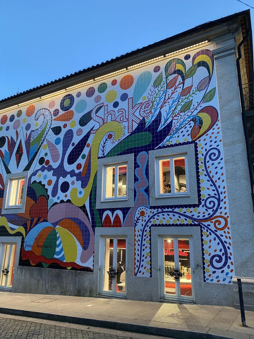 A colorful mural painted on the side of a building.