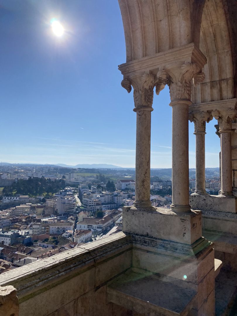 A view of a city from the top of a building.