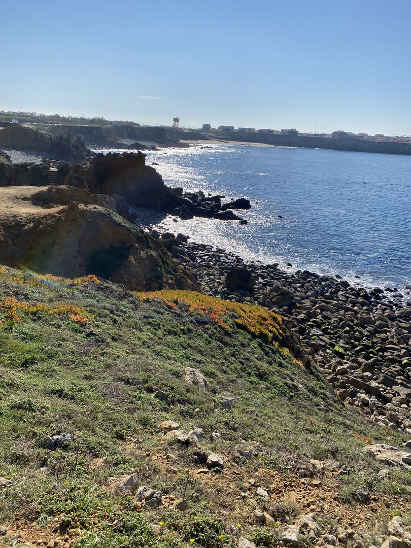 A view of the ocean from a rocky cliff.