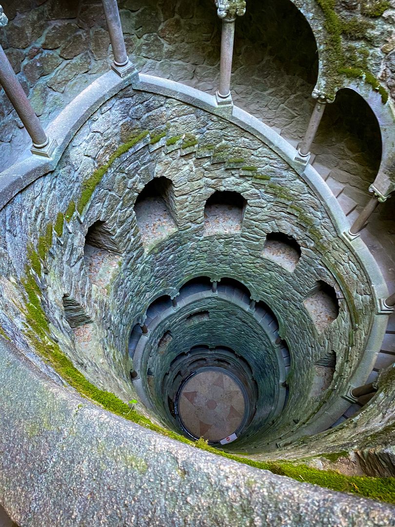 A spiral staircase in a stone building.