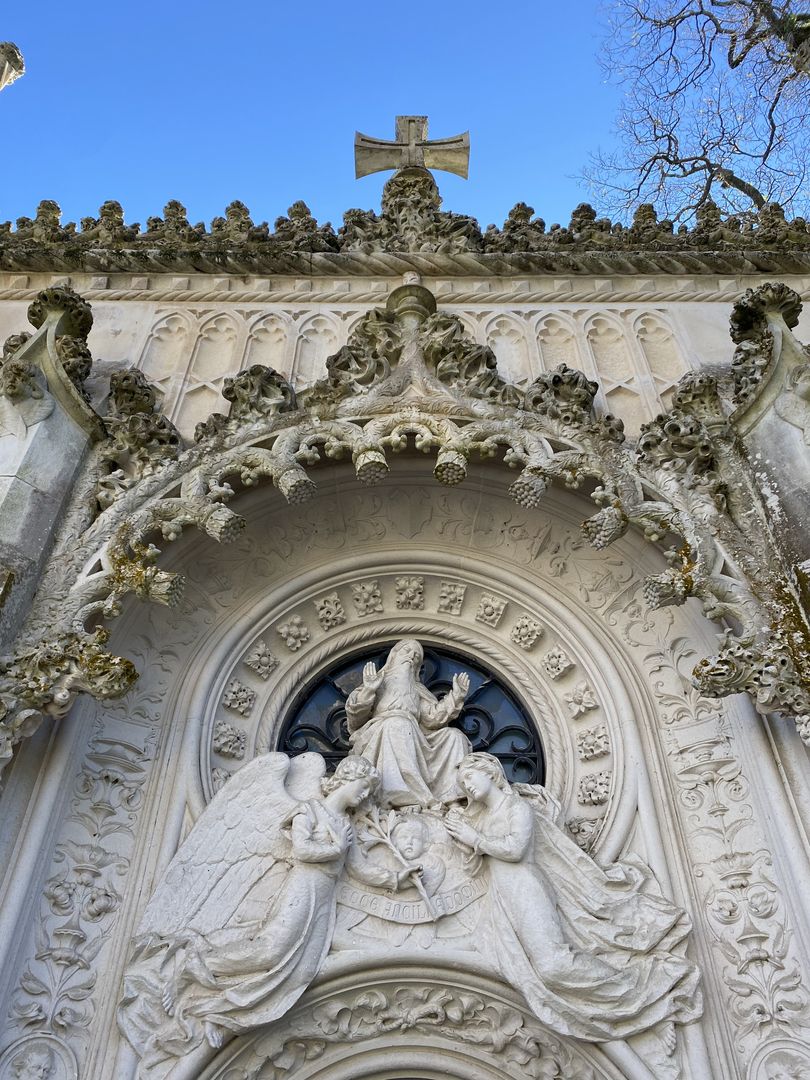 An ornate building with a statue of a cross.