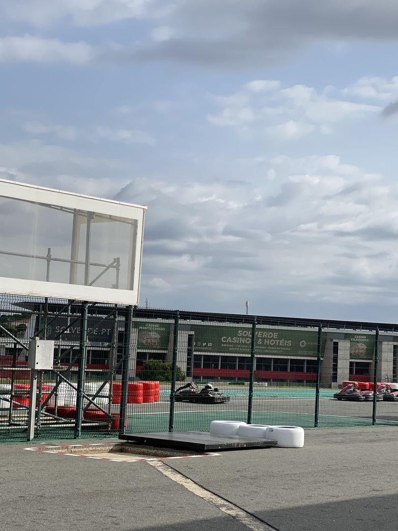 A race track with a fence in the background.