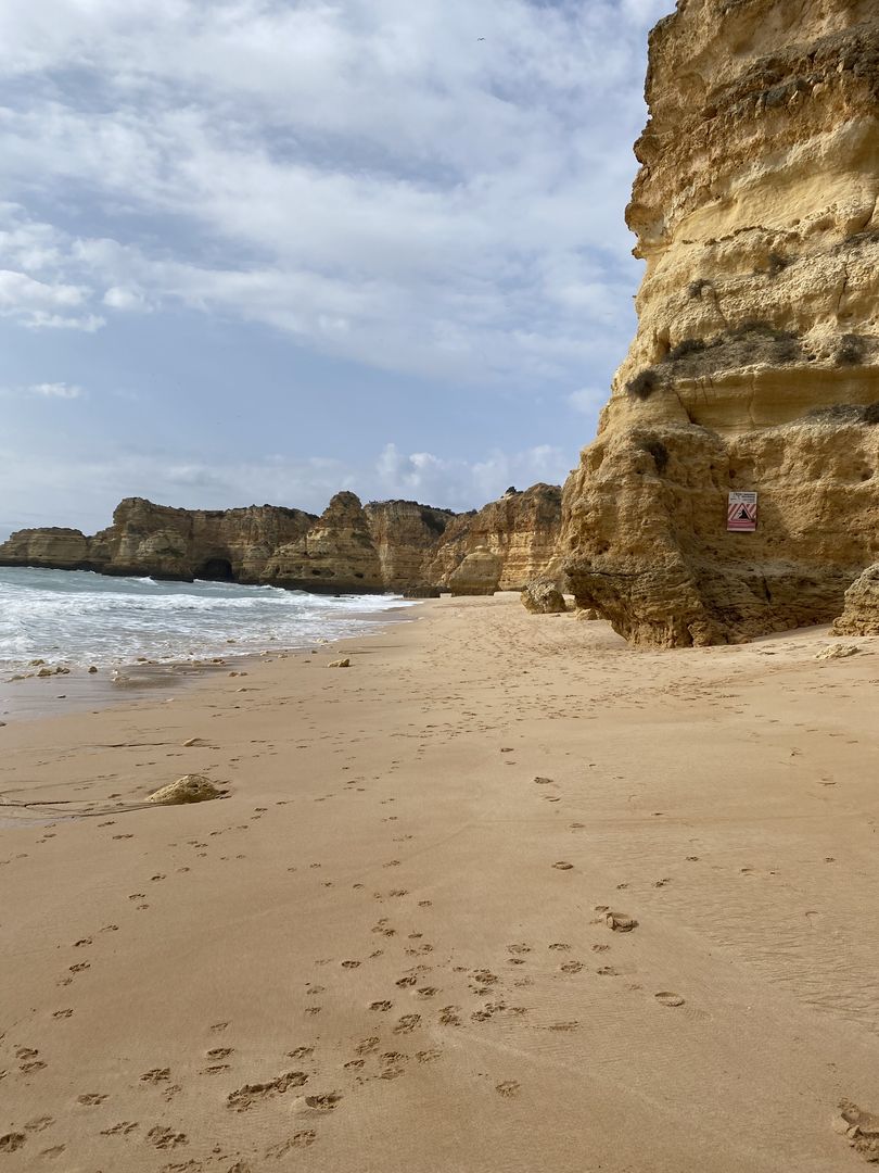 A sandy beach with footprints in the sand.