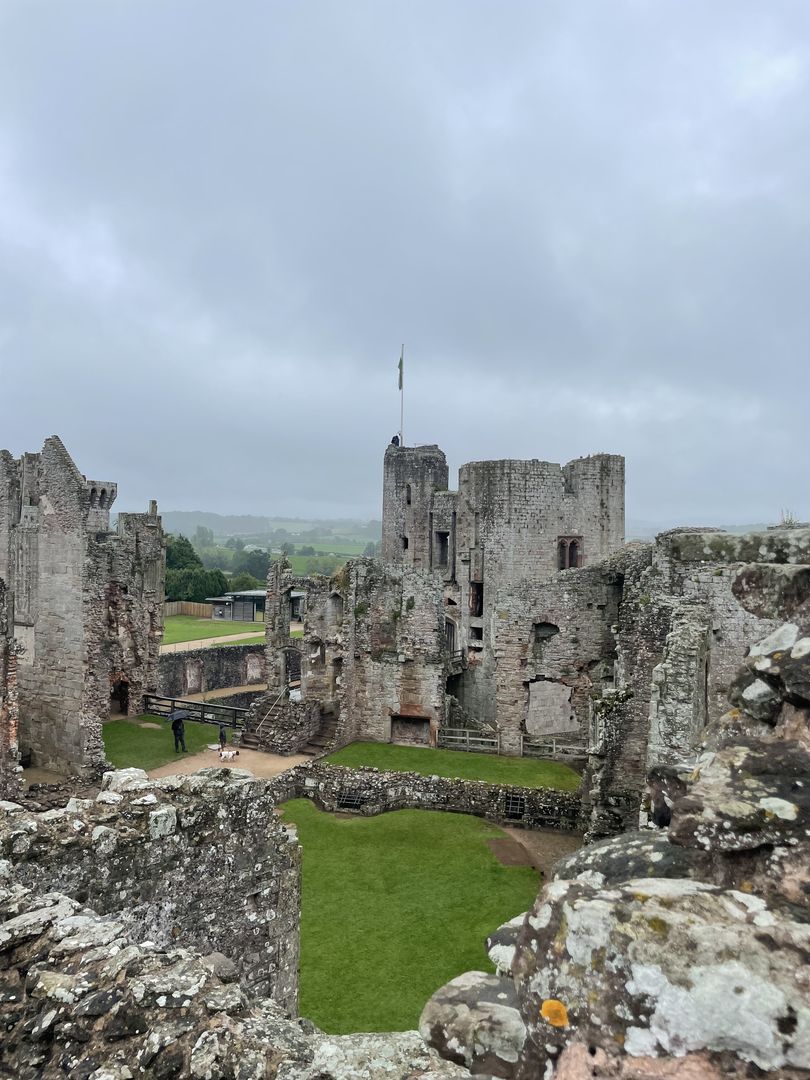 A view of the ruins of a castle on a cloudy day.