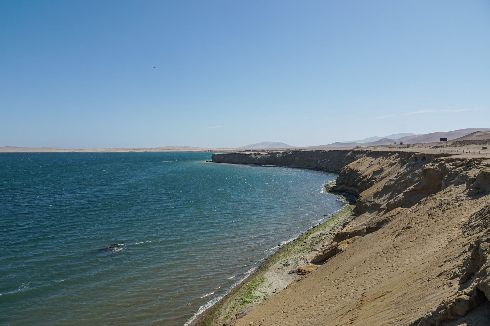 A cliff overlooking a body of water.