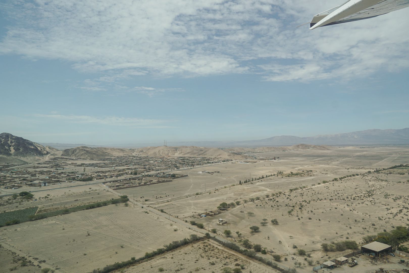 A plane flying over a deserted area.