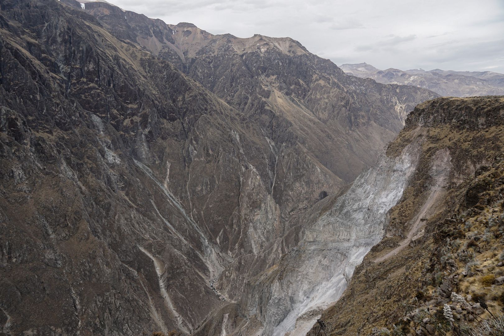 An image of a canyon with a river flowing through it.