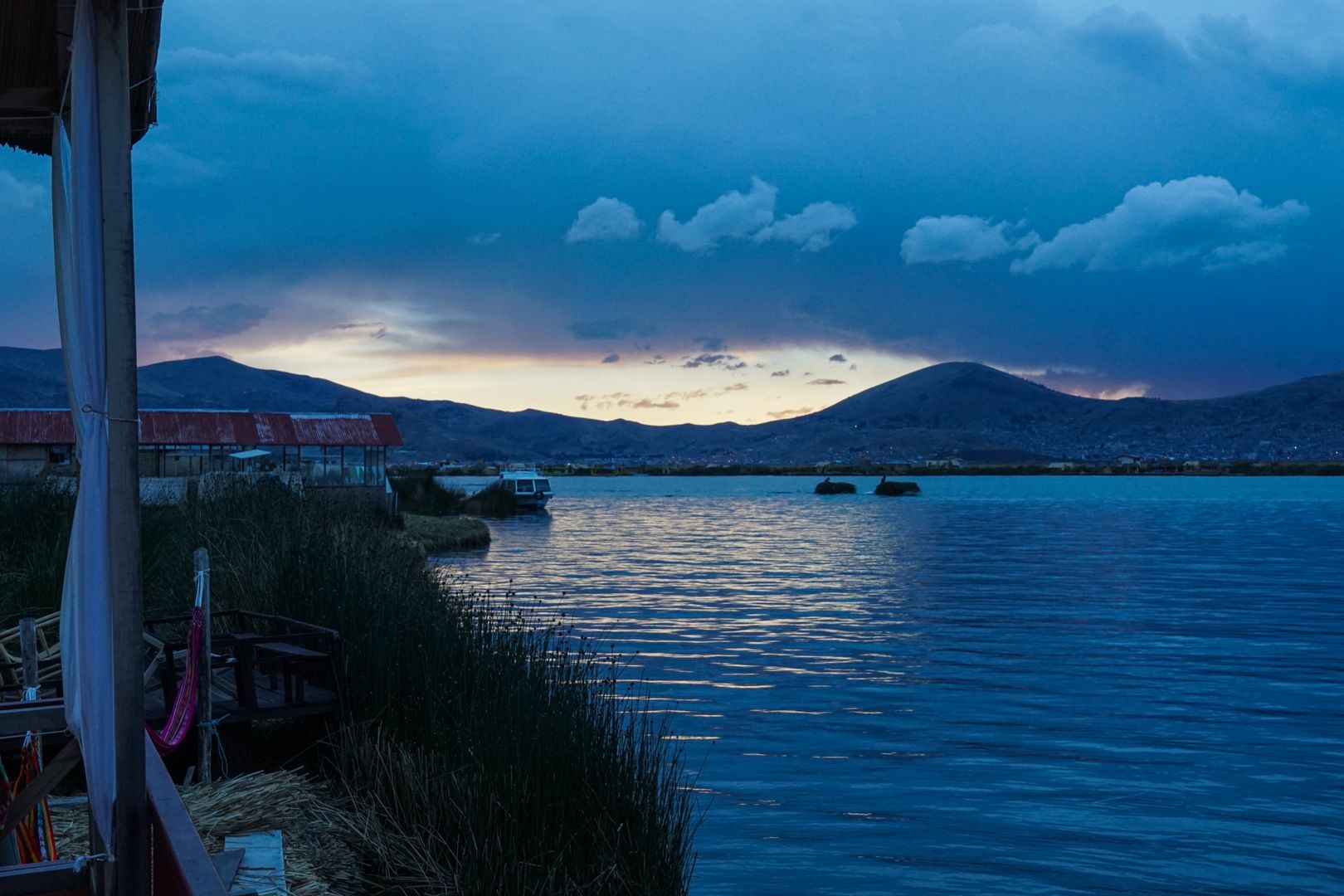 A boat on a lake at dusk.