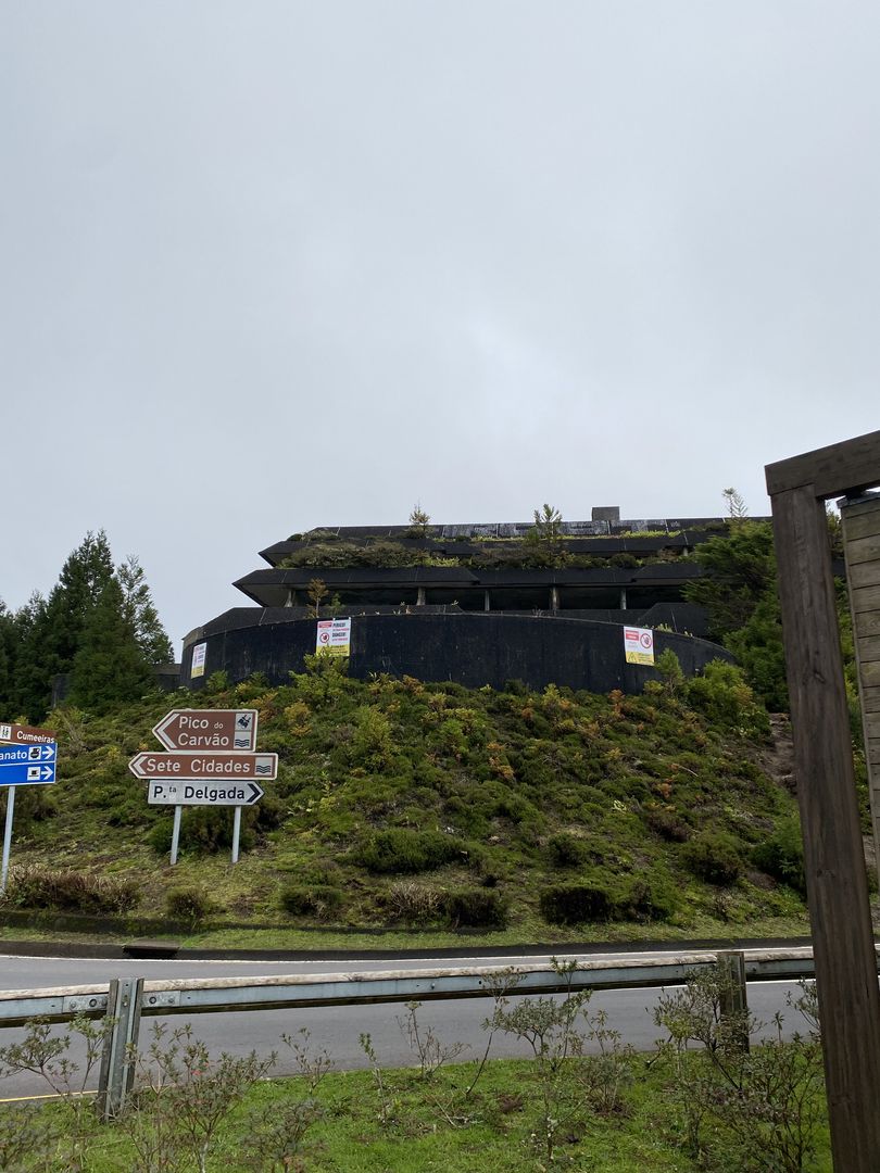 A building on top of a hill next to a road.