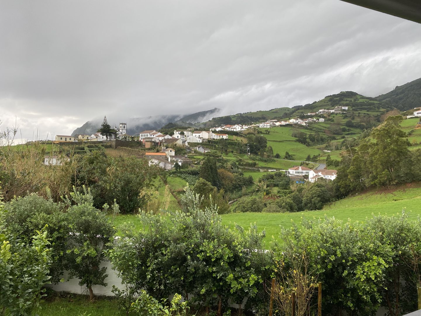 A view from the balcony of a house in the countryside.