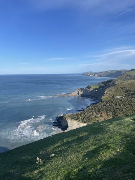 A view of the ocean from the top of a hill.